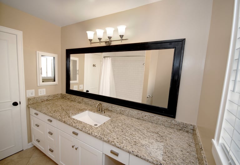 Bathroom with double vanity and granite countertop in a Studio City apartment unit